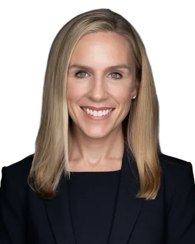 Smiling blonde woman in black blazer with straight hair on white background