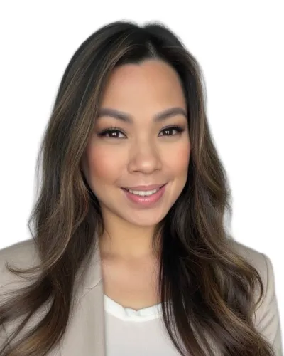 Smiling woman with long dark hair wearing a beige blazer and white top against a white background
