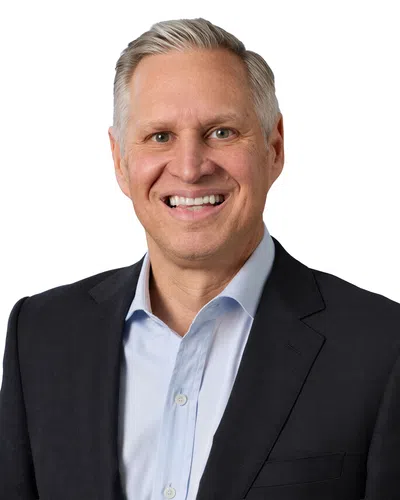 Professional man with a black blaser and blue shirt
