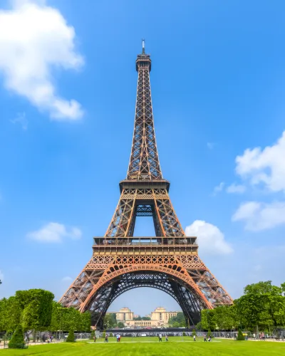 a tall metal tower with Eiffel Tower in the background
