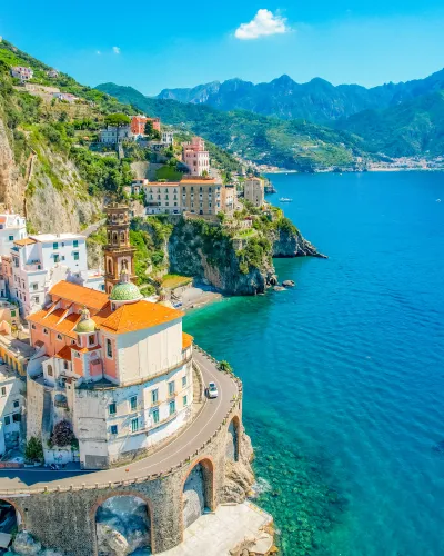 a city on the edge of a cliff over a body of water