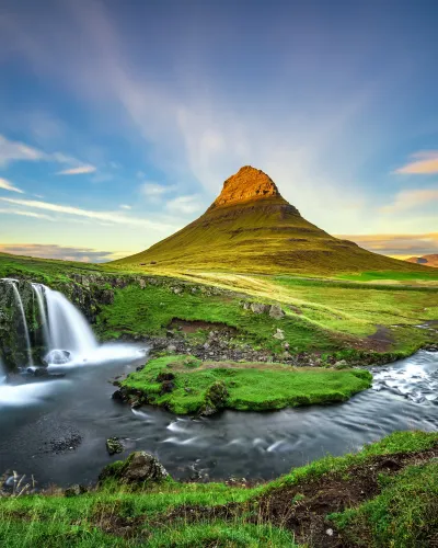 a waterfall and a mountain