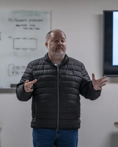 a person standing in front of a whiteboard