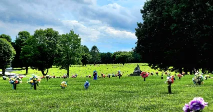a large grassy field with people in it
