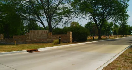 a road with trees and a sign