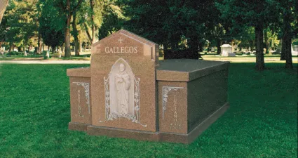 a gravestone in a grassy area