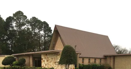 a brick building with a grass yard