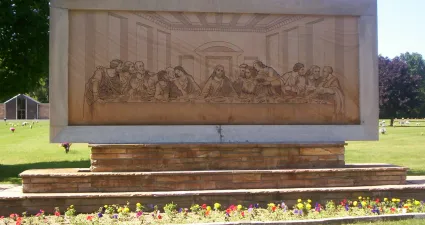 a stone monument with a group of people on it
