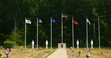 a group of people in white uniforms holding flags