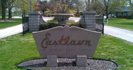a stone sign in a park