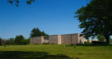 a large building with a grass field