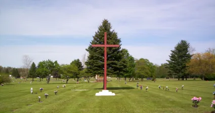 a large red cross in a park