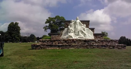 a stone structure with a statue on top of it