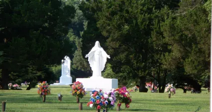 a large white statue in a park