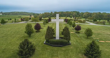 a large green field with a white cross and a large white cross