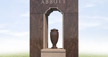 a stone monument with a vase on top