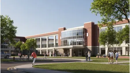 Modern school building with students walking on pathways and green lawns on a sunny day