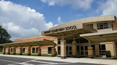 Front entrance of Vander Elementary School under a blue sky with scattered clouds.