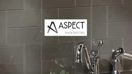 Kitchen sink area with chrome faucet and black peel and stick tile backsplash from Aspect Tiles.