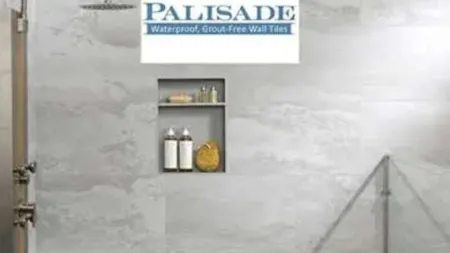 Modern shower with Palisade waterproof, grout-free wall tiles and built-in shelf with toiletries.