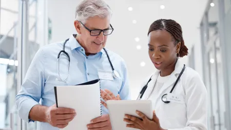 a doctor and a patient looking at a tablet