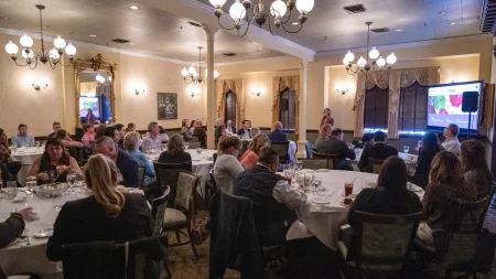 a group of people sitting at tables