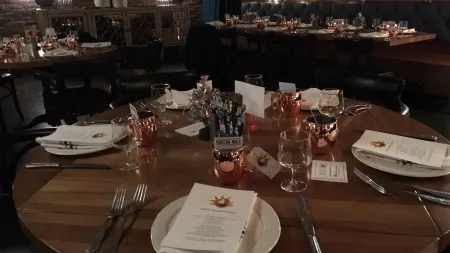 a large dining table with empty glasses