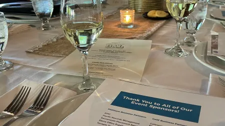 a table with wine glasses and a menu