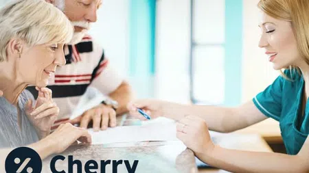 couple at counter in dental office looking at paperwork