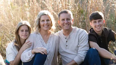 family portrait with teen kids in field