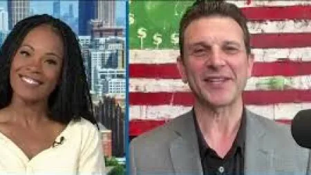 Two people in a video call, woman smiling with city background, man in gray suit with dollar-themed flag behind