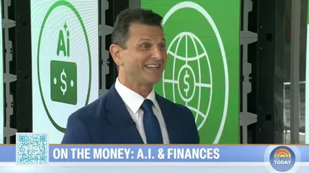 Man in suit smiling during a news segment about AI and finances with related graphics in background