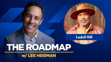 Smiling man in gray suit and man in brown hat featured in The Roadmap podcast with Lee Heisman