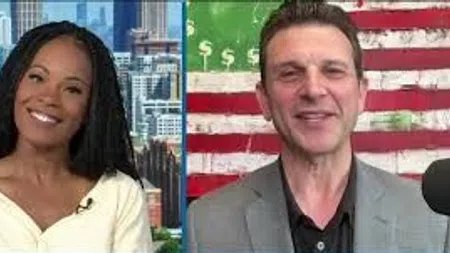 Two people in a video call, woman smiling with city background, man in gray suit with dollar-themed flag behind