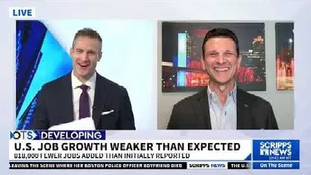Two news anchors smiling during a live broadcast about U.S. job growth being weaker than expected.