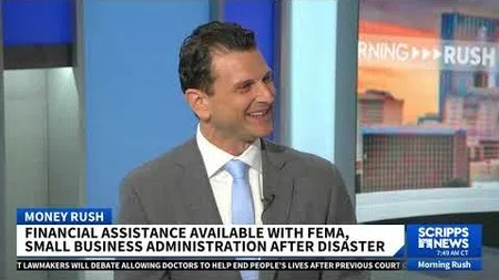 Male news anchor in suit discusses FEMA and SBA disaster financial assistance on Scripps News Morning Rush.