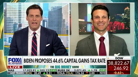 Two news anchors discussing Biden's proposed 44.6% capital gains tax rate on FOX Business live broadcast.