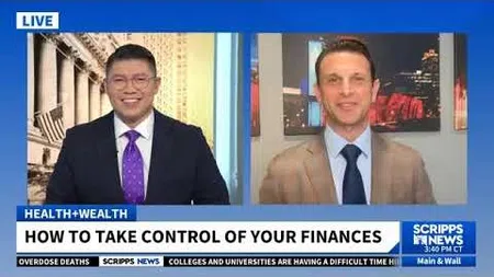 Two men in suits discussing how to take control of your finances on Scripps News live broadcast.