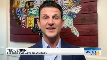 Ted Jenkin, partner at Exit Wealth Advisors, speaks in front of a wooden US map made of colorful license plates.
