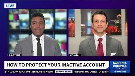 Two male news anchors in suits discussing how to protect inactive accounts on Scripps News live broadcast.