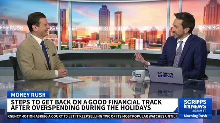 Two news anchors discussing financial tips during Morning Rush on Scripps News with city skyline backdrop.