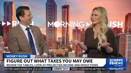 Two news anchors discussing taxes during Scripps News Morning Rush show with city skyline backdrop