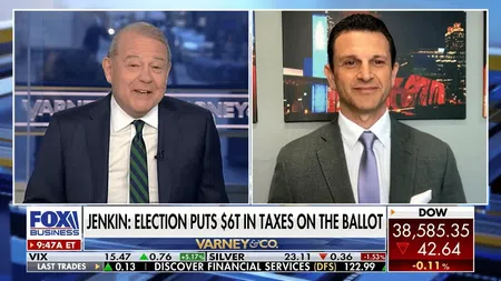 Fox Business segment with two male anchors discussing election tax impact, stock market ticker below.