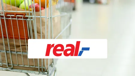 a hand pushing a shopping cart full of eggs