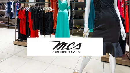 a store with a sign and clothes on display