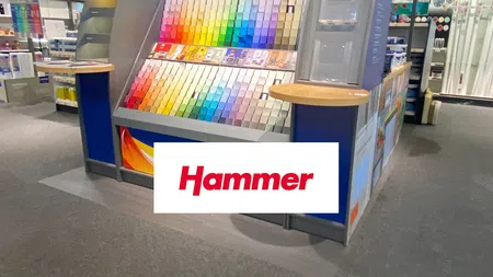 Dulux paint display stand with colorful paint swatches arranged in a gradient and Hammer branding in store.