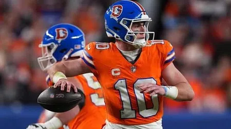 Football player wearing orange Denver Broncos jersey number 10 prepares to throw a pass during a game.
