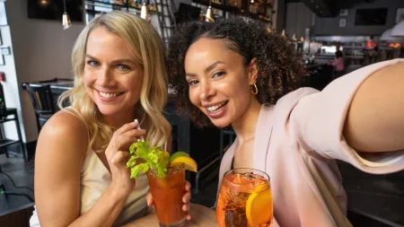 Erin Ross et al. sitting at a table with drinks