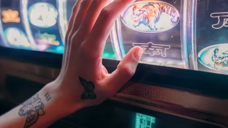 a hand with tattoos on it at a casino