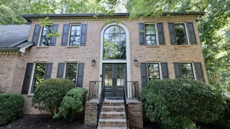 a brick building with a staircase with Owens-Thomas House in the background